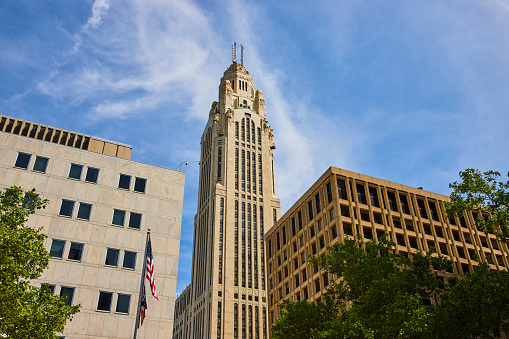 Image of LeVeque Tower Columbus Ohio with American and Ohio flags on summer day