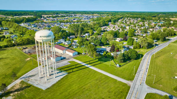 istock Long shadow cast by tall white Huntertown water tower in summer 1567431273