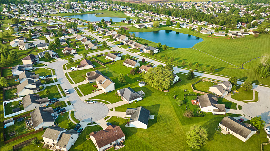Image of Middleclass neighborhood large ponds aerial lush green summer trees and grass