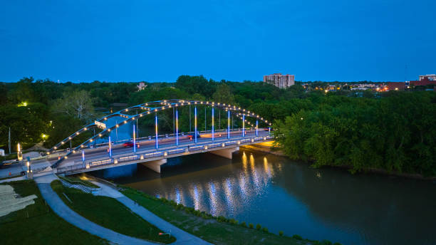 The Bob Kerrey Pedestrian Bridge footbridge across the Missouri River between Council Bluffs, Iowa, and Omaha, Nebraska at night. Omaha is the largest city in the state of Nebraska.  Omaha is known for is steak, hospitality, performance venues, museums, musical heritage nature and cultural experiences