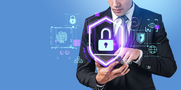 istock Businessman with device and protective shield with lock hologram, cybersecurity 1567440692