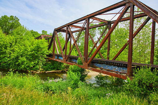 Image of Old train bridge cutting through forest with Kokosing River