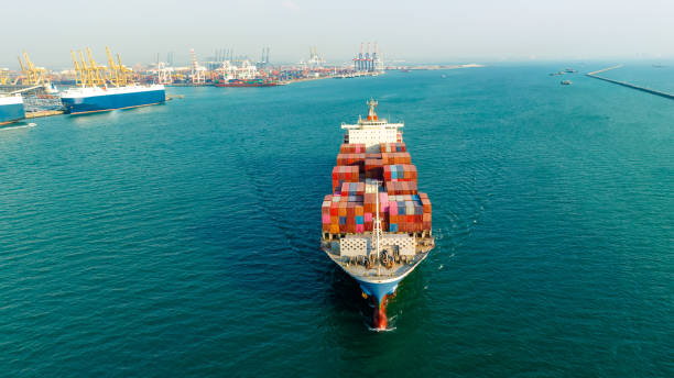 istock cargo container ship carrying in sea to import export goods and distributing products to dealer and consumers across asia pacific worldwide, global business and industry delivery service  by container ship Transport. 1567455894