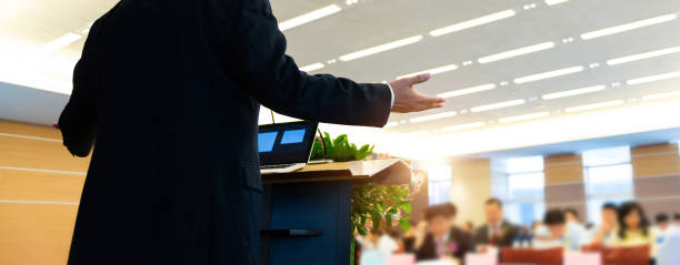 istock Business man making a speech in front of big audience 1567470752