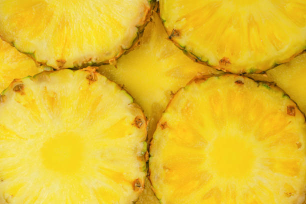 istock Pineapple juicy yellow slices as a background. 1567471267