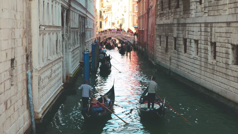 View from Ponte della Paglia to the Bridge of Sighs, Palace Canal (Rio di Palazzo) and gondolas with tourists. Venice, Italy.