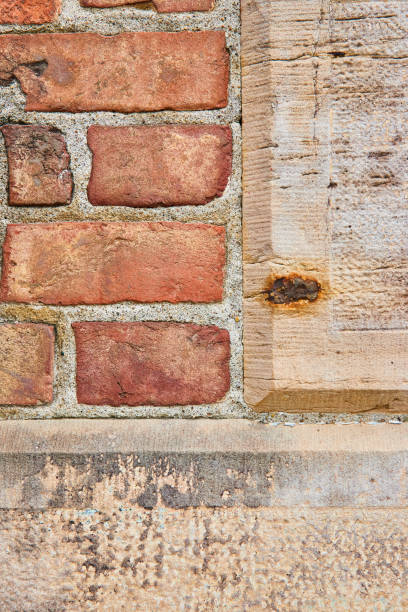 istock Tan concrete blocks with rough texture on wall with red bricks background asset 1567475369