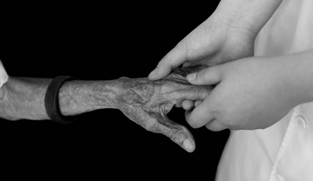 istock Young hands holding an old woman's wrinkled hands 1567477623