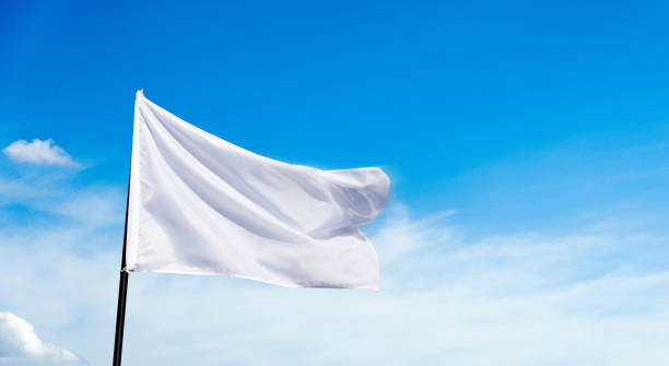 istock White flag flying against blue sky background 1567480498