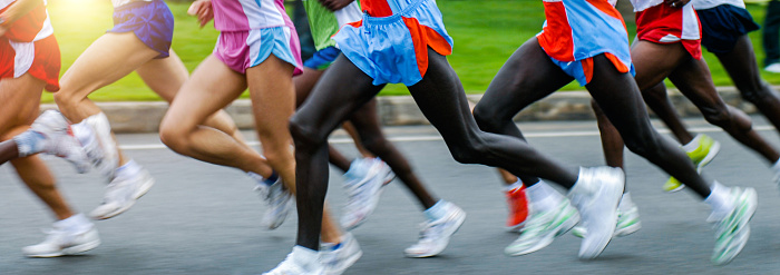 Side view of athletes running in a cross country race