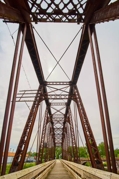 istock Vertical of walking bridge inside converted old railway train bridge in Mount Vernon Ohio 1567486088