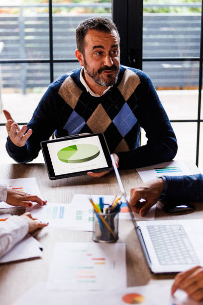 istock Businessman showing a chart on digital tablet during a project meeting 1567508265