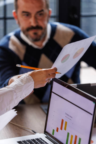 istock Business colleagues reviewing a project document and discussing strategies 1567508270