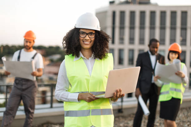 istock Diverse architects examining building blueprints in open air 1567510478