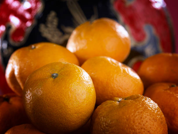 istock a basket of mandarin oranges with lotus 1567512715
