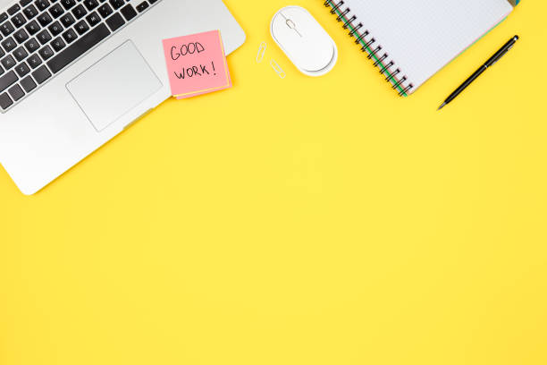 istock Laptop, notepad and paper reminder on yellow background, top view. 1567520534