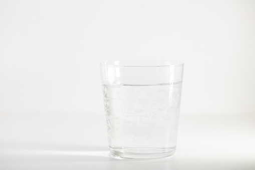 Glass with pure water isolated on white background
