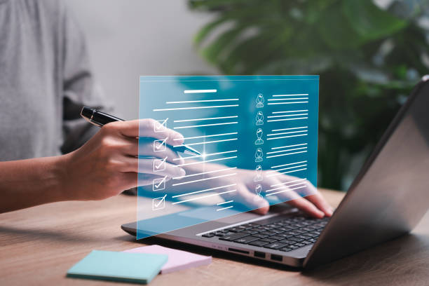 istock Education technology and smart business concept, Female teachers use laptops to check smart data  list of students, Check practice information online convenient, fast, and modern 1567535984