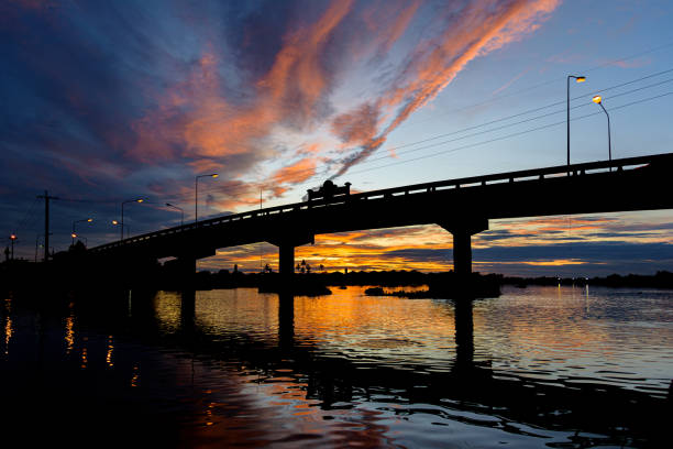 istock Sunset over Tha Chin River and Ruamjai Chalermprakiet Bridge 1567544843