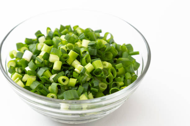 istock Chopped green onions on a white background. 1567546006