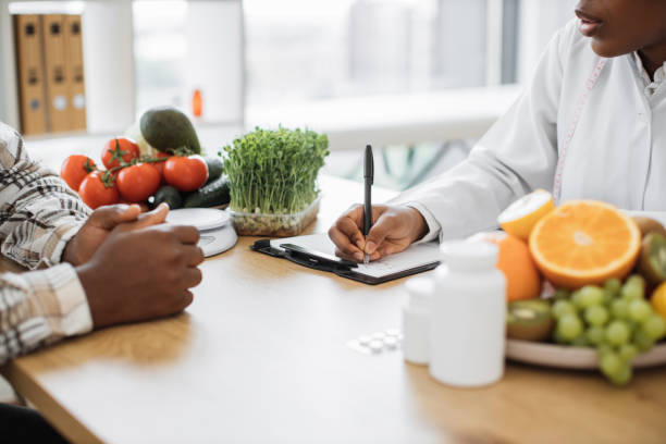 istock Nutritionist making notes at desk with medicine and products 1567548704