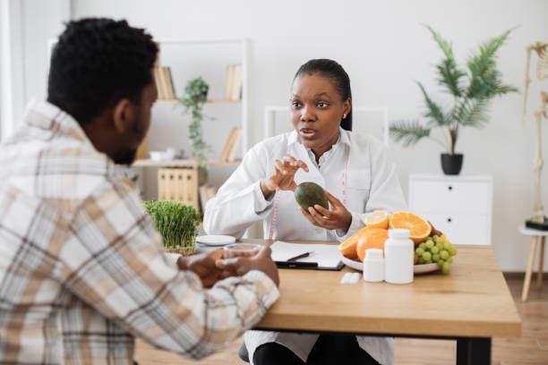 istock Medical specialist holding avocado during consultation 1567548705