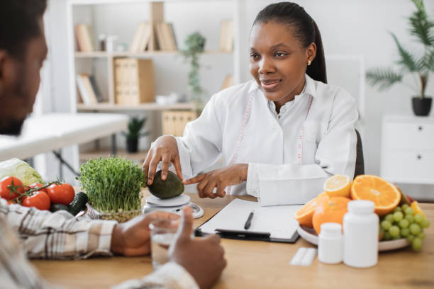 istock Lady putting avocado on nutrition scale during appointment 1567548724