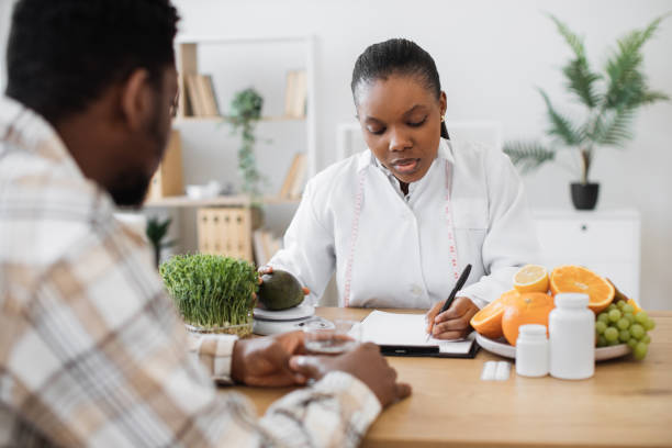 Expert in diet writing down details of meals for patient
