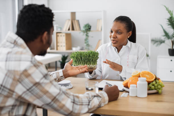 istock Nutritionist showing microgreens to client in clinic 1567549271