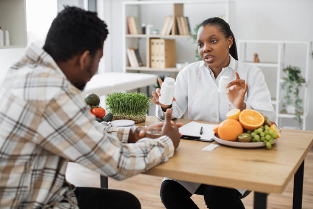 istock Dietitian talking to man about vitamin supplements in office 1567549320