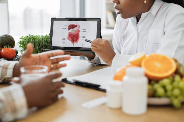 istock Lady with device analyzing GI treatment with male patient 1567549842