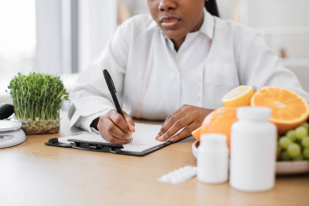 istock Food expert writing meal plan on clipboard in workplace 1567549860