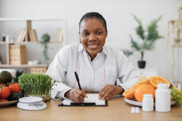 istock Nutritionist with pen making changes in diet plans in office 1567549864