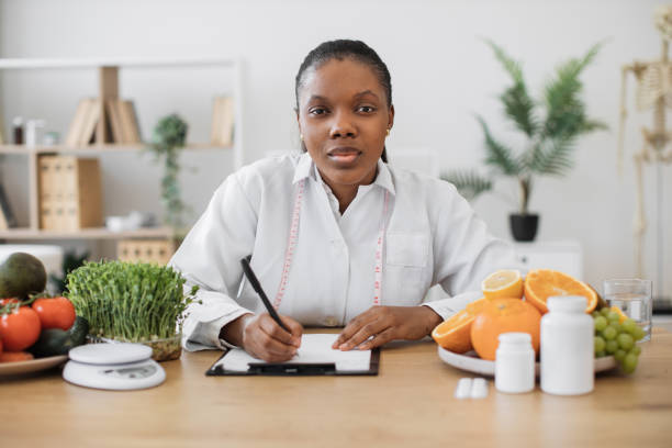 istock Nutritionist with pen making changes in diet plans in office 1567549869