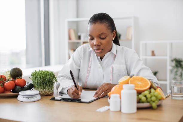 istock Specialist writing down client's diet data at office desk 1567549881