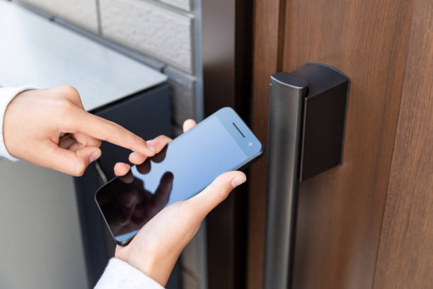 istock The hand that unlocks the front door with a smartphone. 1567554317