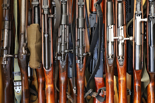 Rifles and machine guns in gun cabinet