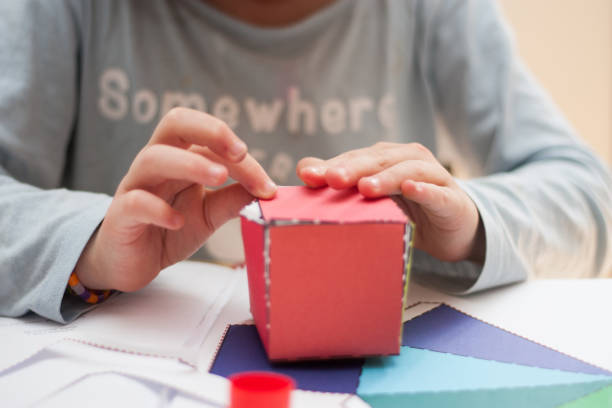 istock girl doing crafts at the table at home 1567581789