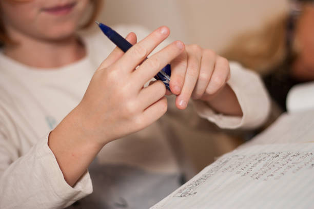 istock boy writing letter at the table at home 1567582831