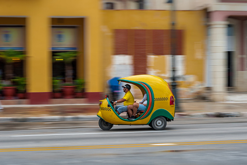HAVANA, CUBA - OCTOBER 21, 2017: Tuk Tuk Driver and Vehicle in Havana, Cuba