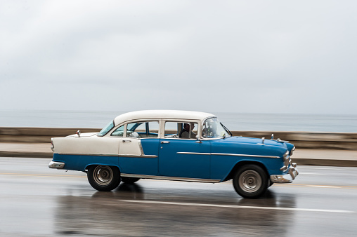HAVANA, CUBA - OCTOBER 21, 2017: Old Car in Havana, Cuba. Panning. Retro Vehicle Usually Using As A Taxi For Local People and Tourist. Blue Color