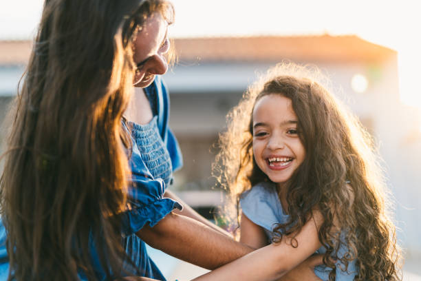 istock Sisters laughing and playing at sunset in the backyard 1567600234