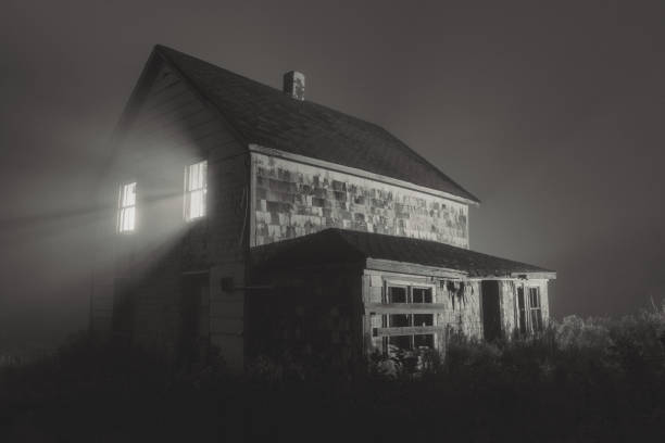 Heavy fog engulfs an abandoned home in rural Nova Scotia.  Long exposure with light painting, toned black and white.