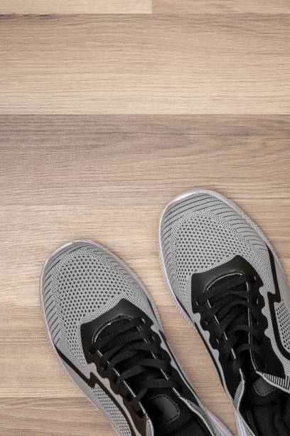 Close up of unrecognizable woman tying her shoelace before starting her jog at the park - Healthy lifestyles