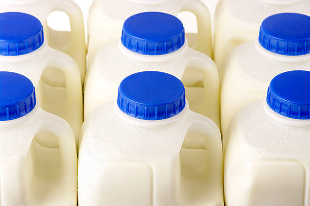 Pint Milk Containers Arranged In Rows Pint milk containers arranged in rows.http://www.djwhite.co.uk/photog/headers/food_tle.jpg blue jug stock pictures, royalty-free photos & images