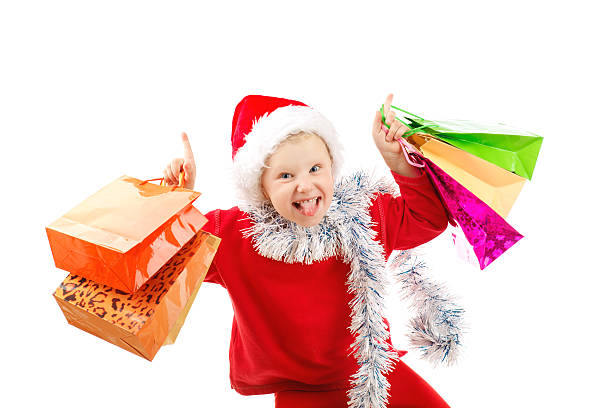 Child dressed as Santa with presents stock photo