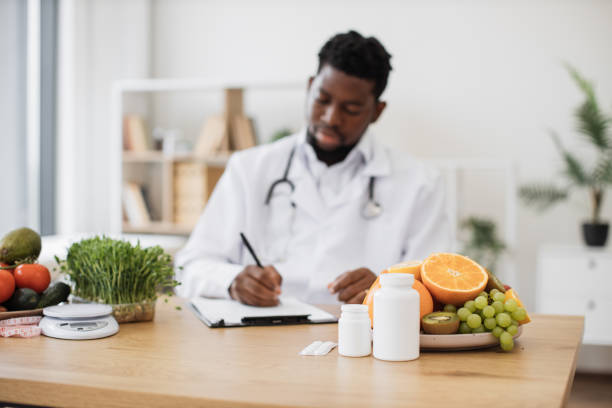 istock Fruits and pills bottles being kept on desk at doctor's 1567620192