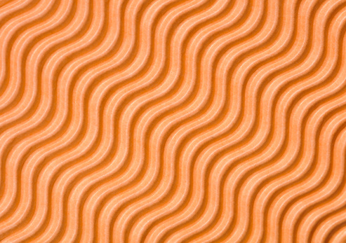 Close up detail of a piece of natural kraft wave flute single face corrugated board,