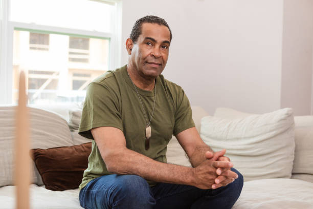 Mature male veteran sits on the couch while waiting for his therapy appointment