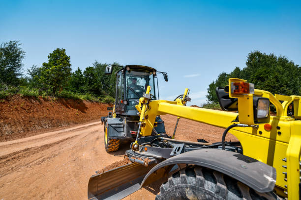istock Professional Worker Driving Grader Towards Designated Spot On Site 1567664299